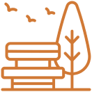 Park bench and tree with flying birds.