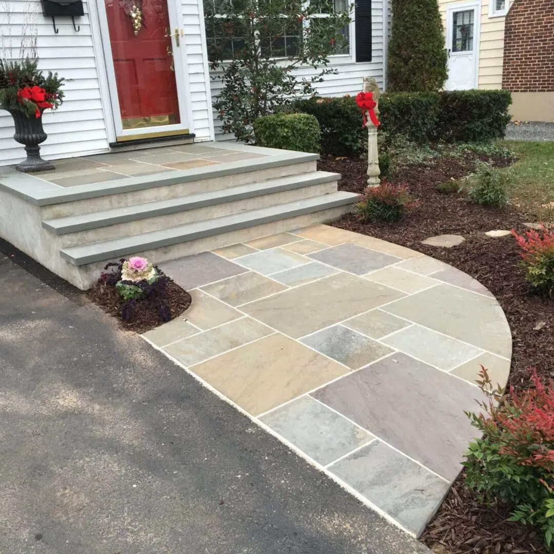 Newly installed stone walkway leading to front steps of a home.