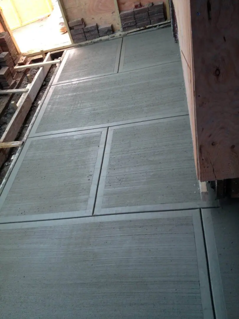 Close-up of a concrete wall with a wooden frame beside it.