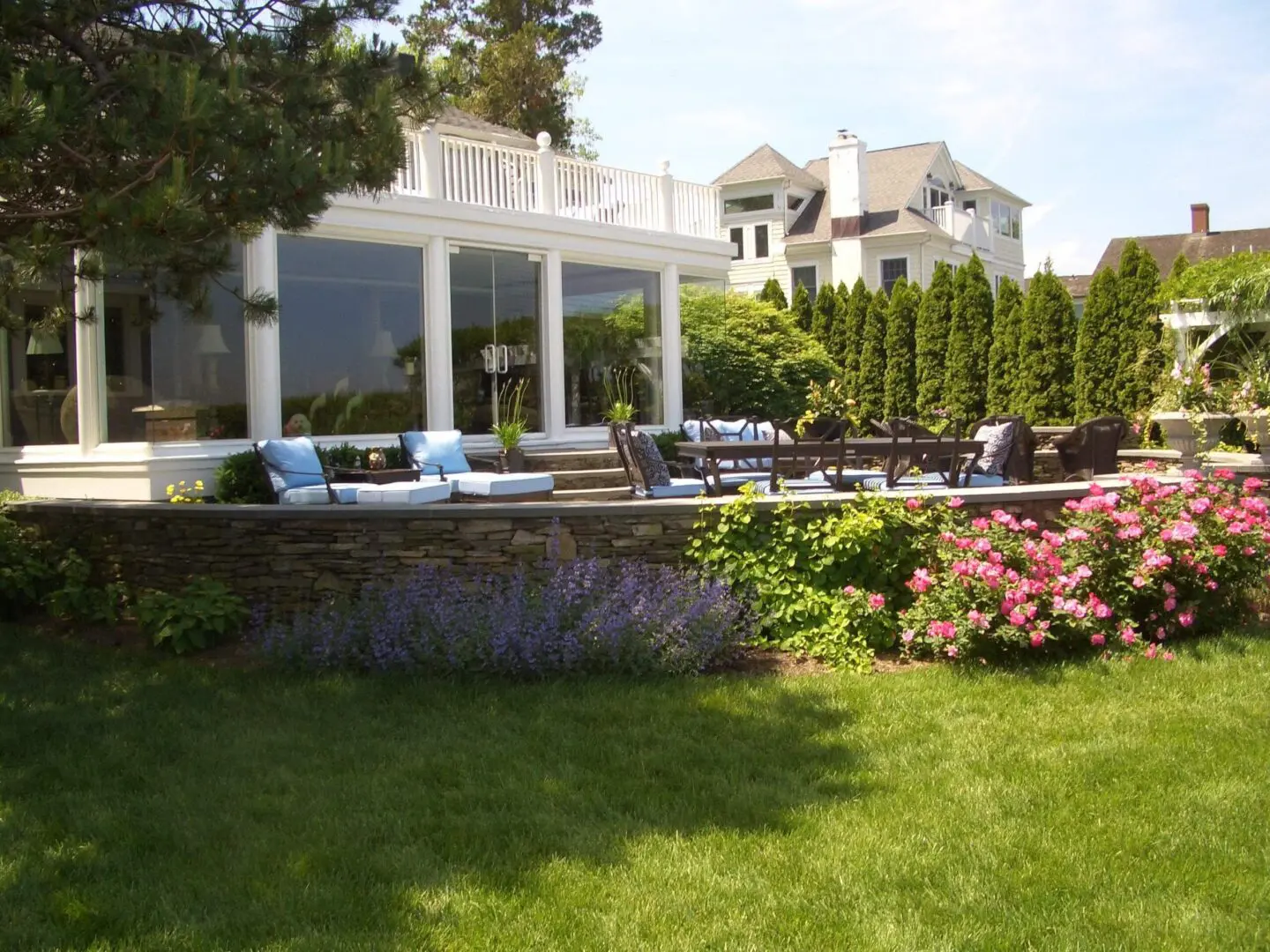 Elegant backyard with a patio, pool, and lush garden.