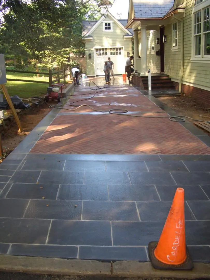 Newly paved driveway with a mix of stone and concrete finishes.
