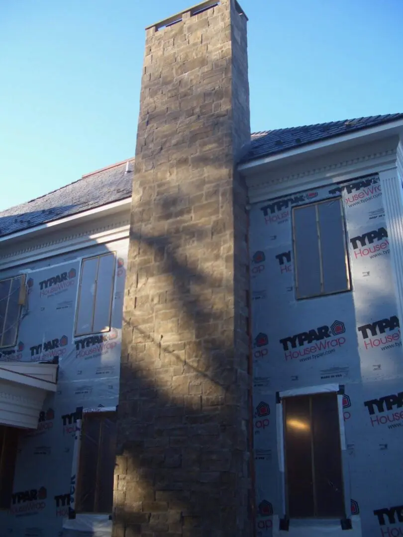 Chimney shadow cast on a house under construction.