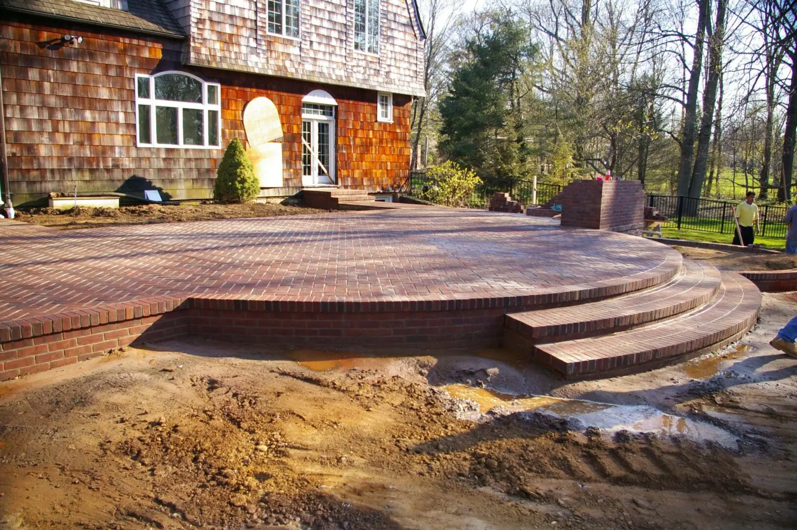 Newly constructed wooden deck with steps in a backyard.