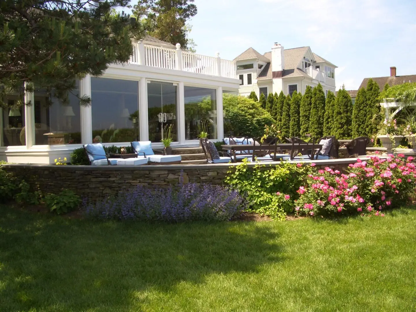 Elegant backyard with a patio, pool, and lush garden.