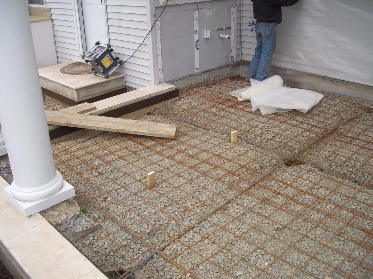 Metal mesh laid for concrete slab foundation preparation.